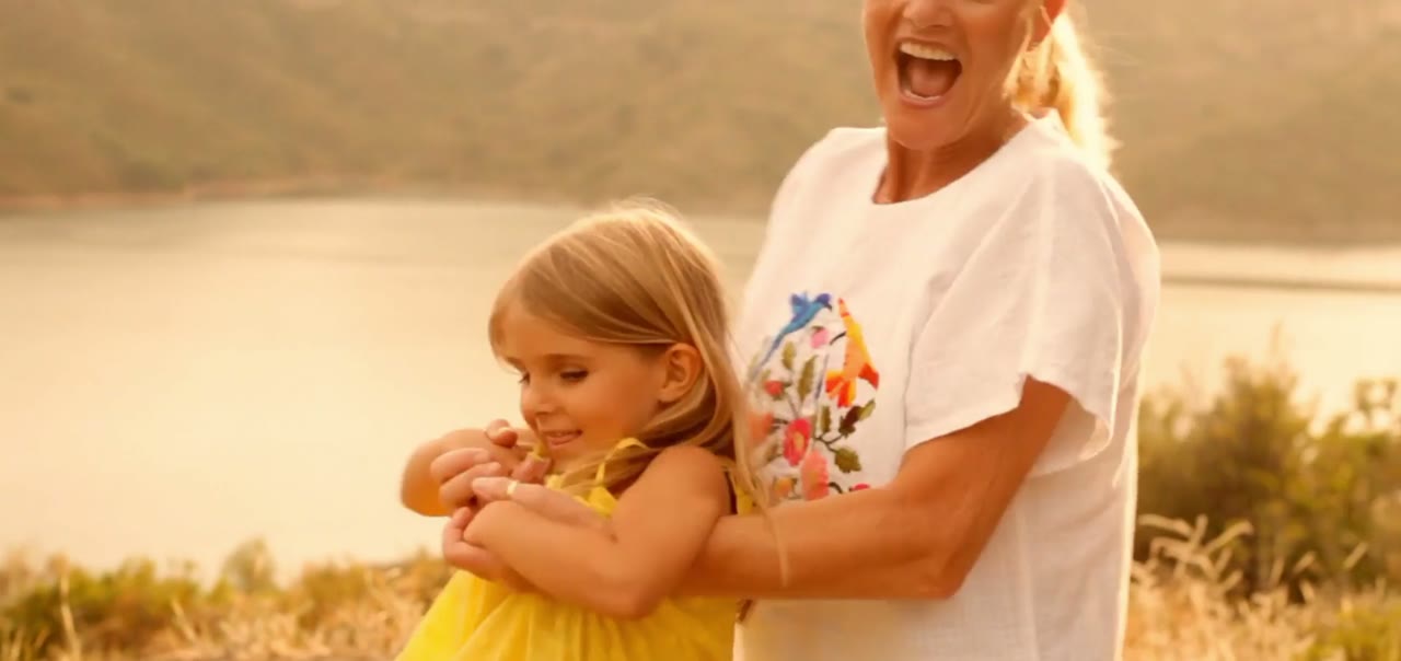 A grandmother holding a small child outdoors