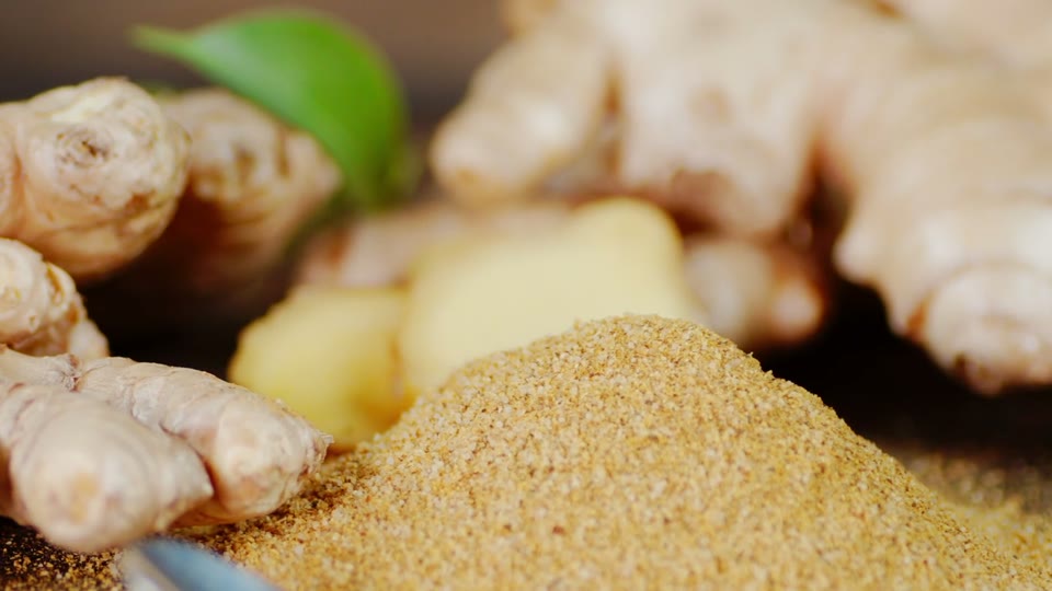 Fresh ginger root beside ground ginger